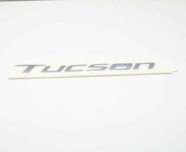 86310N9000 - Hyundai Tucson NX4 MK4 Tailgate Emblem 86310N9000, Original Part