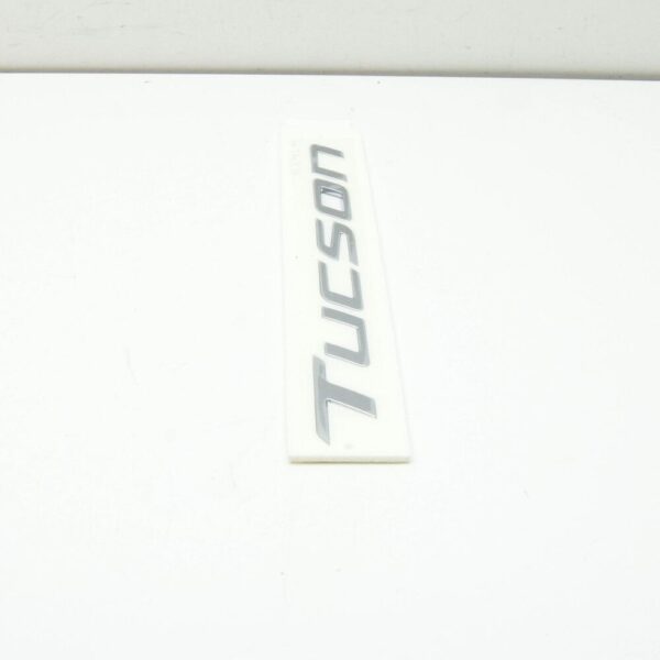 86310N9000 - Hyundai Tucson NX4 MK4 Tailgate Emblem 86310N9000, Original Part