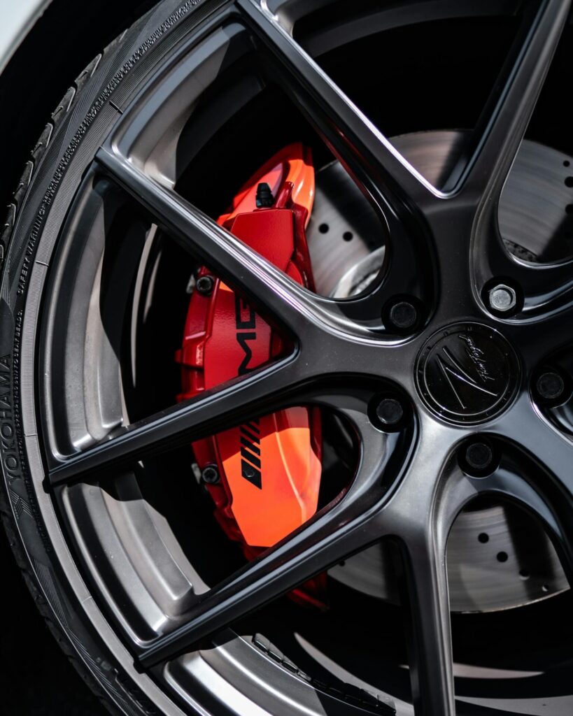 About 17 Detailed shot of a high-performance car wheel with vibrant red brake caliper.